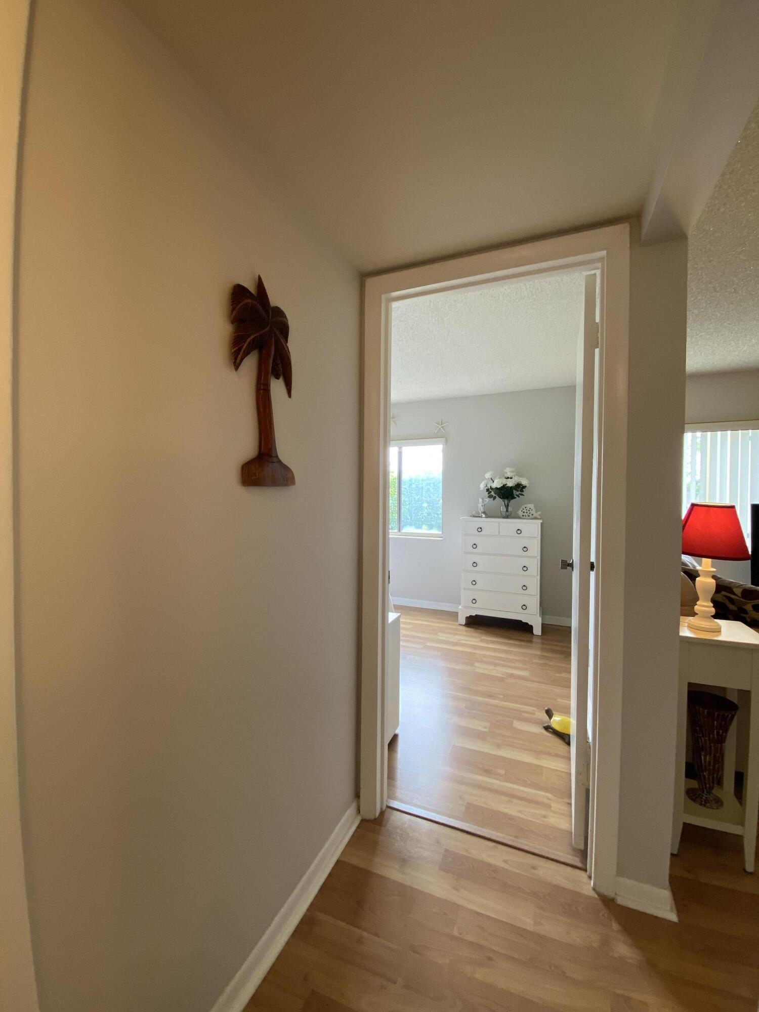 302 Pine Ridge Circle, Unit D1 Greenacres, FL 33463 - Photo 25 of 46 a view of a hallway and wooden floor and a livingroom