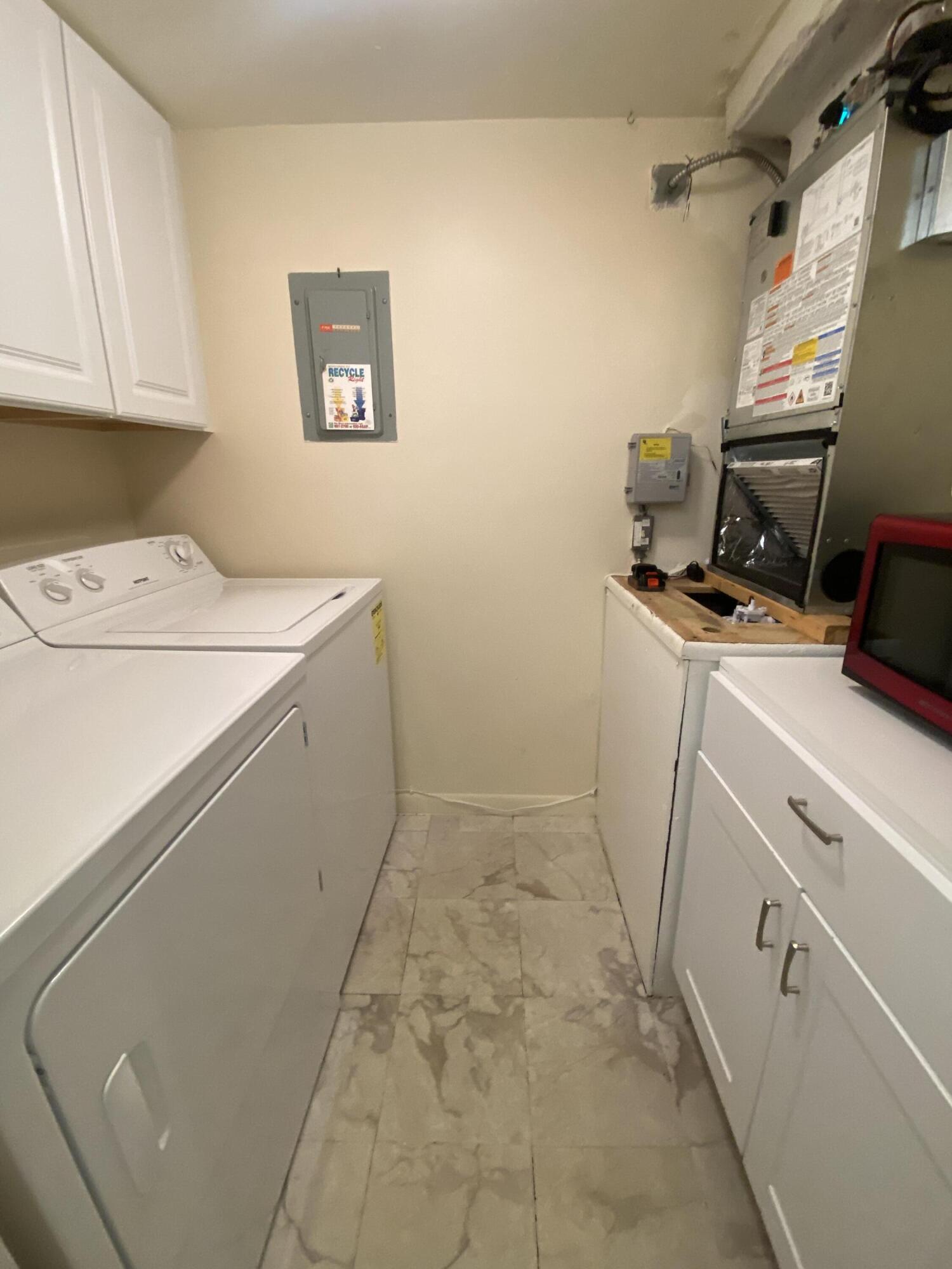 302 Pine Ridge Circle, Unit D1 Greenacres, FL 33463 - Photo 30 of 46 a utility room with dryer and washer