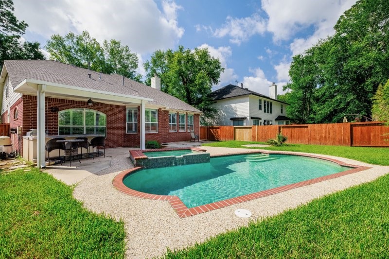 19 East Popular Pine Northeast Conroe, TX 77302 - Photo 1 of 20 a view of a house with a yard patio and a patio
