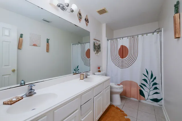 a bathroom with a sink a mirror and a toilet