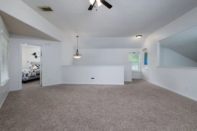 a view of a livingroom with furniture and natural light