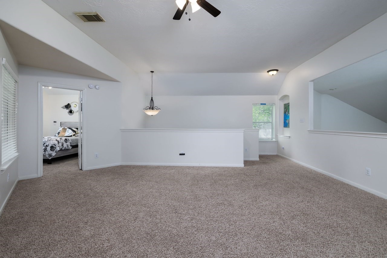 19 East Popular Pine Northeast Conroe, TX 77302 - Photo 18 of 20 a view of a livingroom with furniture and natural light