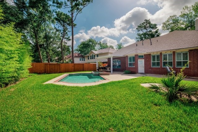 19 East Popular Pine Northeast Conroe, TX 77302 - Photo 19 of 20 a view of a house with backyard and sitting area