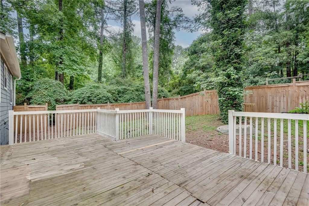 5611 Whittondale Road Lithonia, GA 30058 - Photo 28 of 34 a view of deck with wooden fence and trees