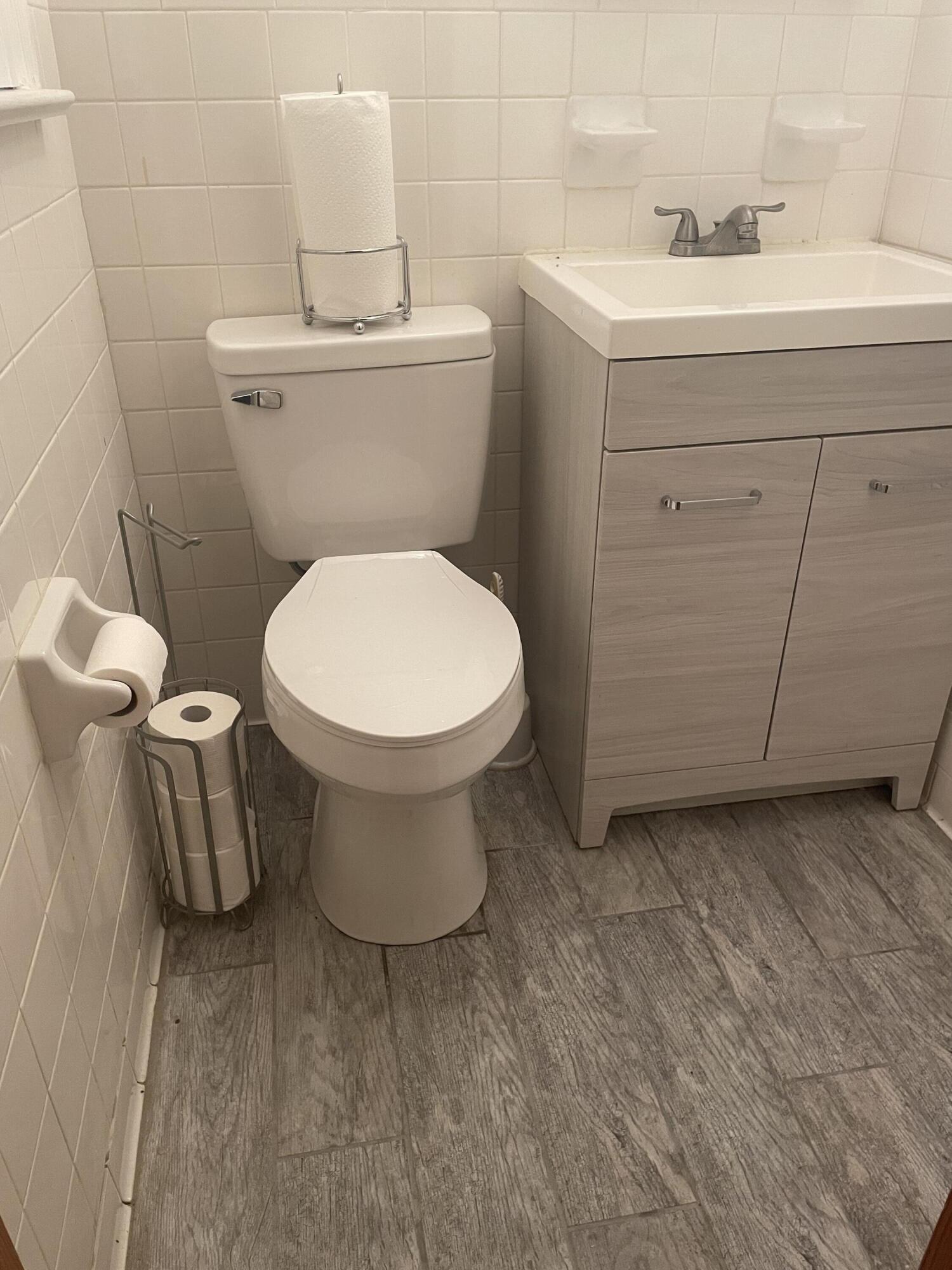 7592 Willow Branch Road Boones Mill, VA 24065 - Photo 15 of 47 a white toilet sitting next to a bathroom sink