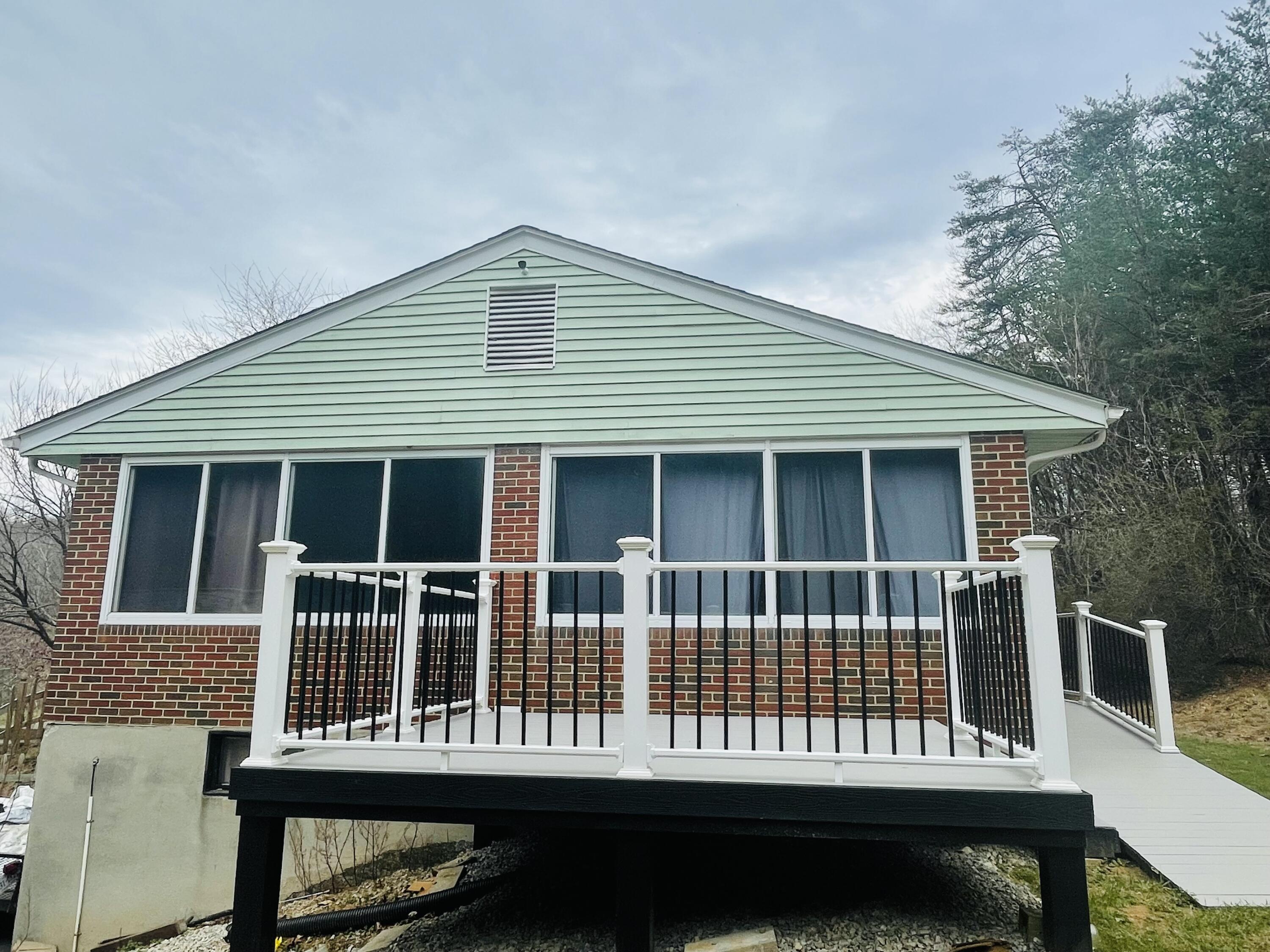 7592 Willow Branch Road Boones Mill, VA 24065 - Photo 20 of 47 a view of a house with a deck and furniture