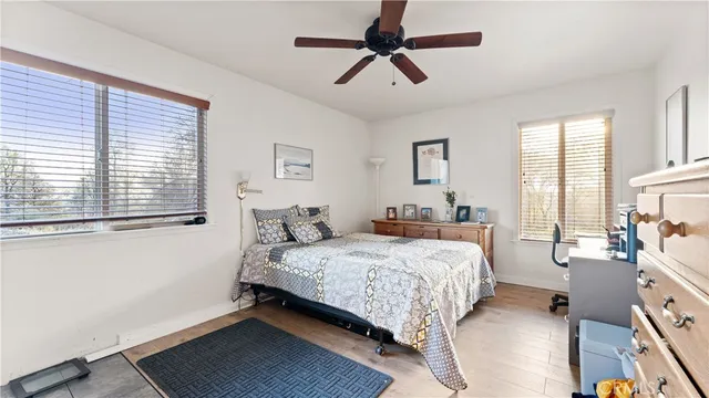 a bedroom with a bed a dresser and a window