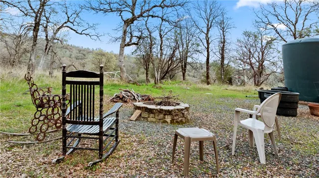 a view of a chairs and table in backyard