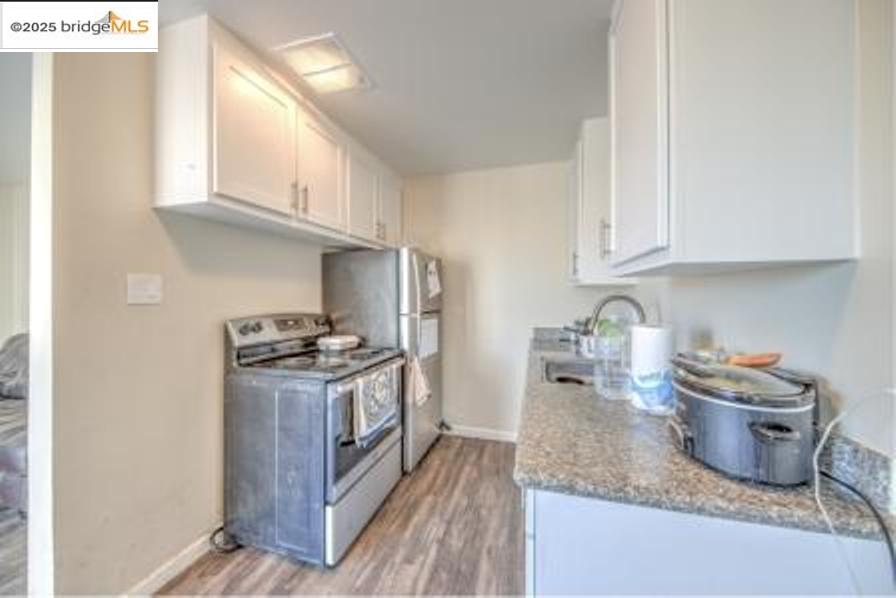 601 Alabama Street Vallejo, CA 94590 - Photo 14 of 17 a kitchen with granite countertop a stove and a sink