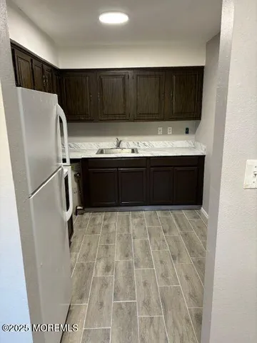 a kitchen with a refrigerator and a sink