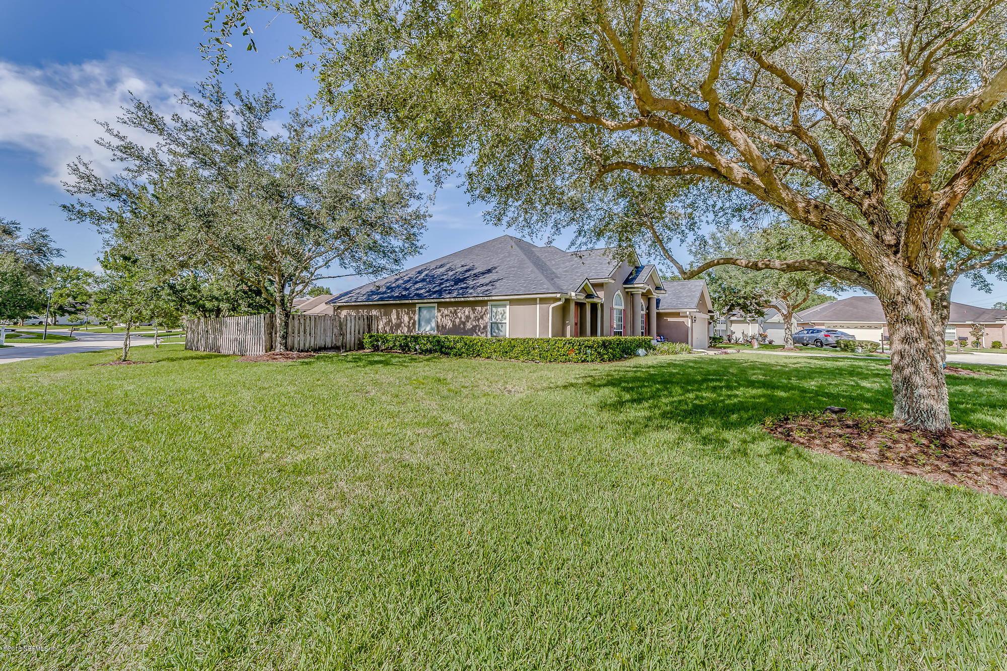 5442 Spring Ridge Court Jacksonville, FL 32258 - Photo 54 of 57 a backyard of a house with lots of green space