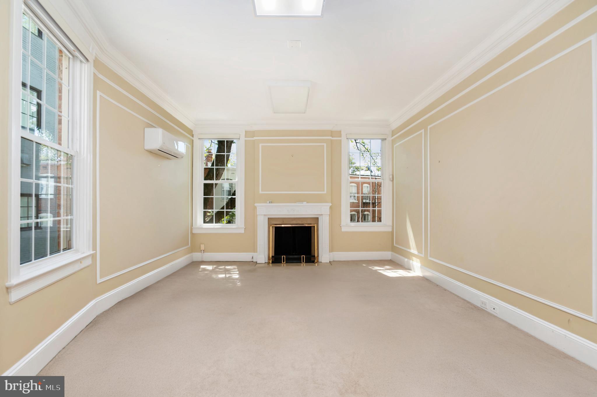 2232 Massachusetts Avenue Northwest Washington, DC 20008 - Photo 19 of 21 wooden floor fireplace and windows in an empty room