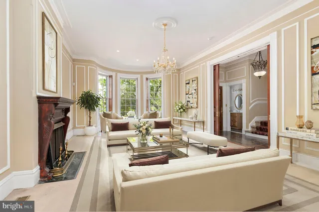 a living room with furniture a large window and a chandelier