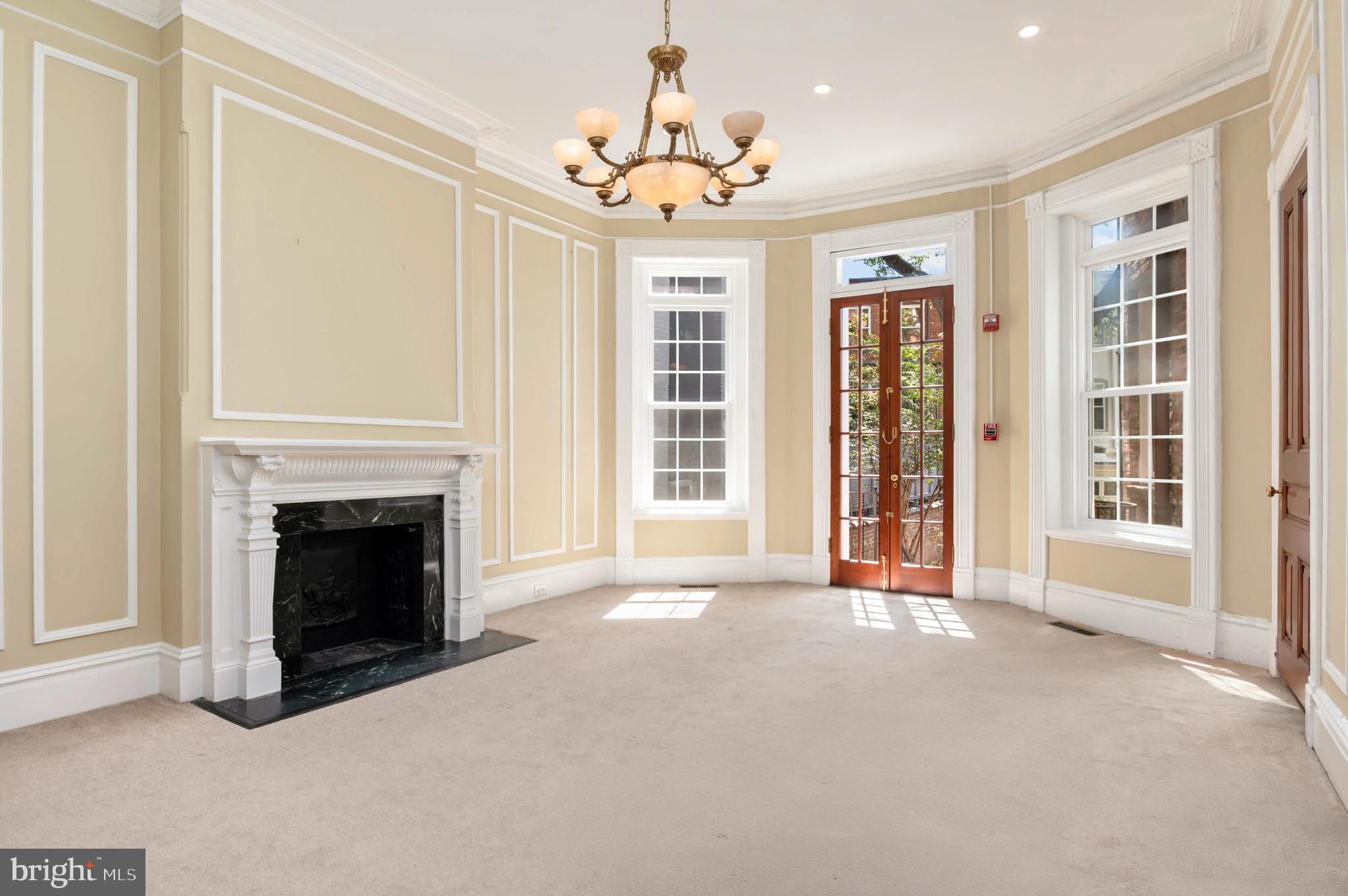 2232 Massachusetts Avenue Northwest Washington, DC 20008 - Photo 7 of 21 a view of an empty room with fireplace and a window