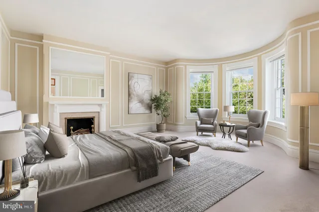 a bedroom with a large bed and a fireplace