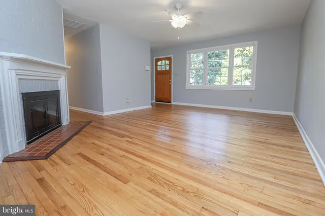 a view of a house with a yard and potted plants
