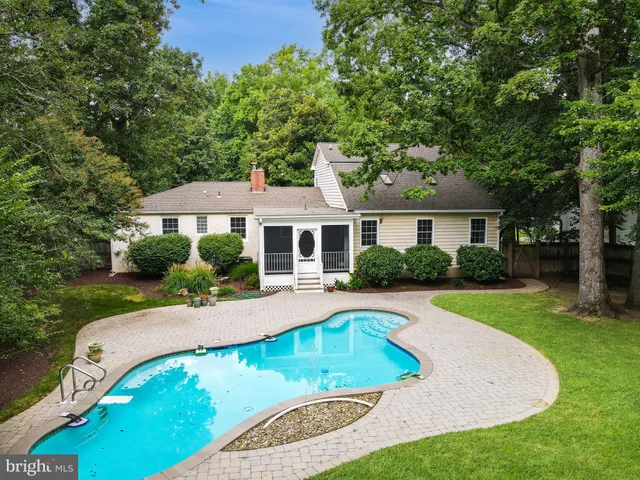 a living room with furniture and a dining table