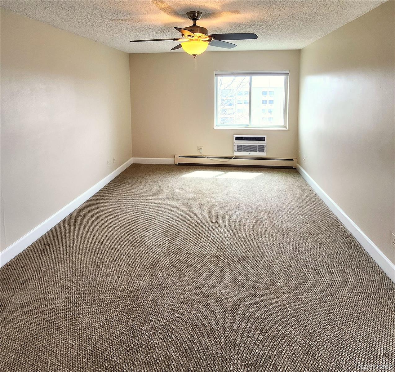 13890 East Marina Drive, Unit 602 Aurora, CO 80014 - Photo 14 of 27 an empty room with windows and fan