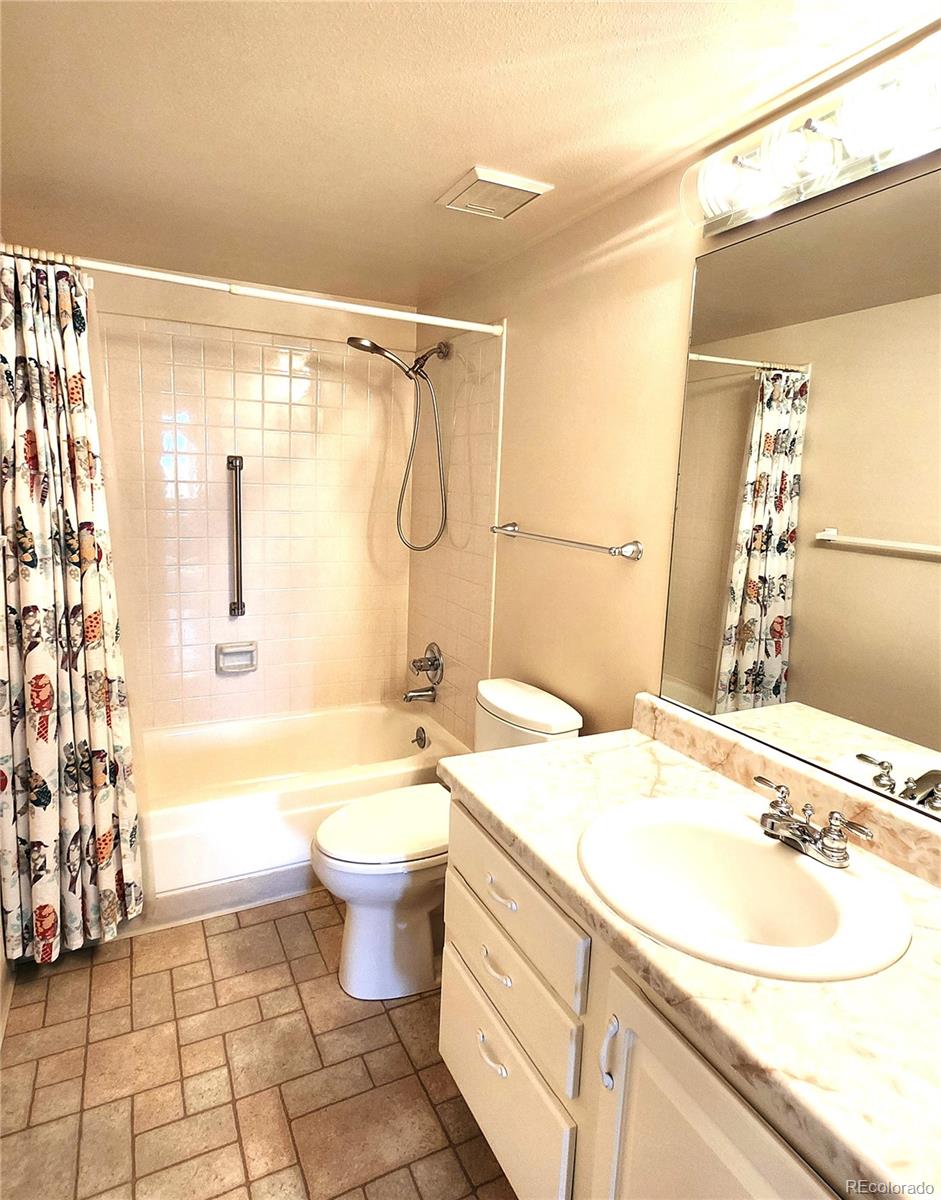 13890 East Marina Drive, Unit 602 Aurora, CO 80014 - Photo 18 of 27 a bathroom with a sink toilet and shower