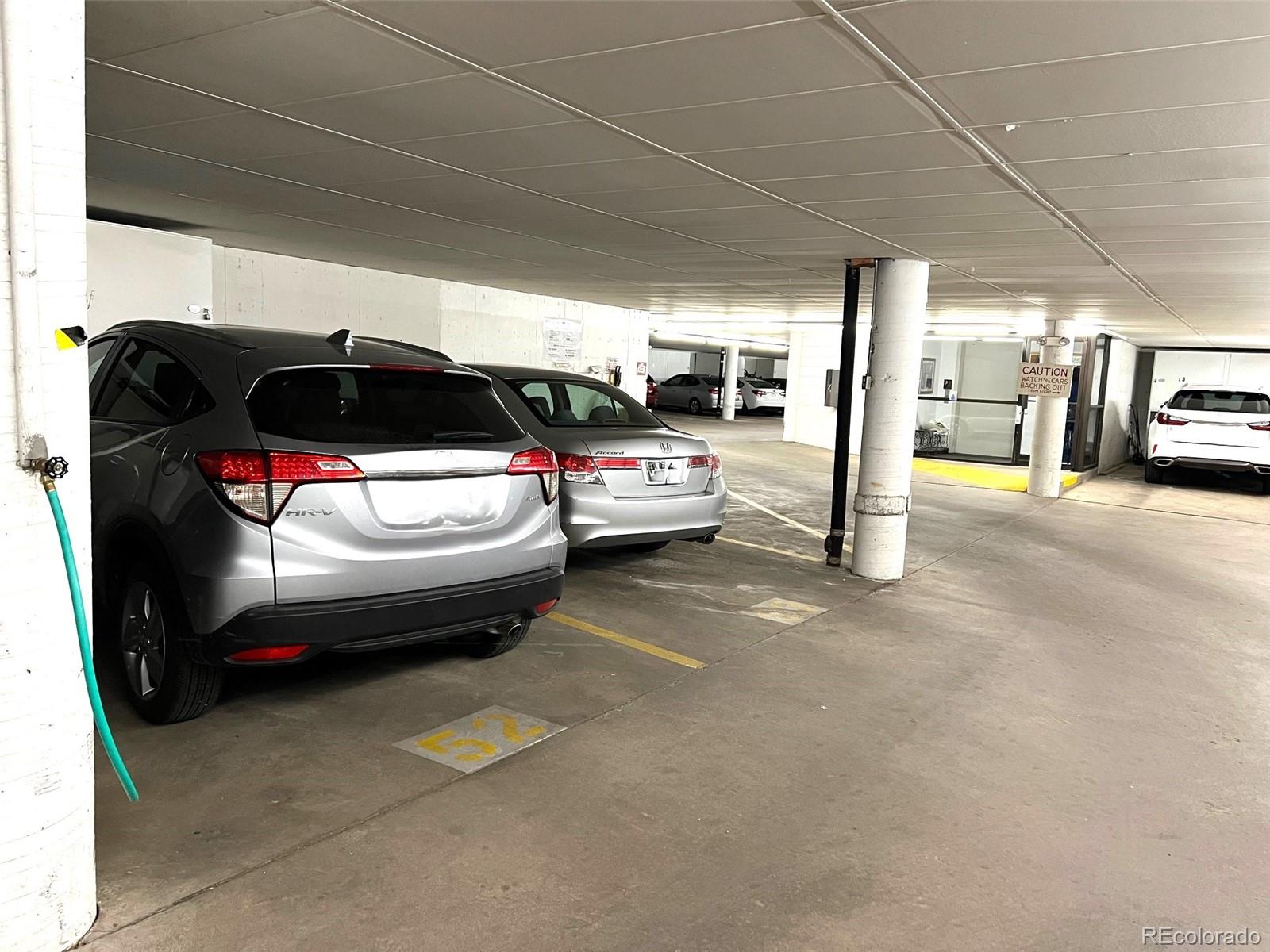 13890 East Marina Drive, Unit 602 Aurora, CO 80014 - Photo 21 of 27 a view of parking garage with cars parked