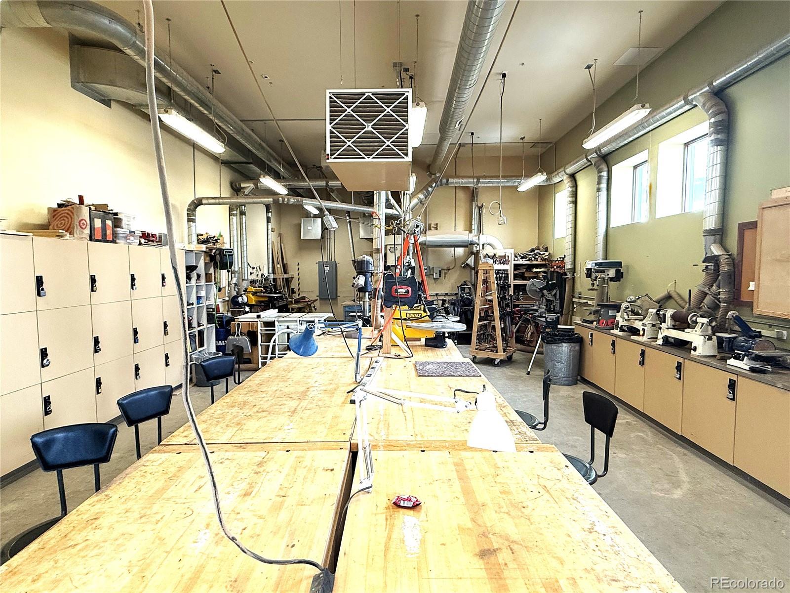13890 East Marina Drive, Unit 602 Aurora, CO 80014 - Photo 24 of 27 a living room with lots of chairs and chandelier