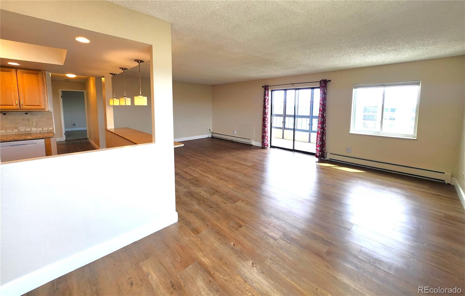 13890 East Marina Drive, Unit 602 Aurora, CO 80014 - Photo 4 of 27 an empty room with wooden floor and windows