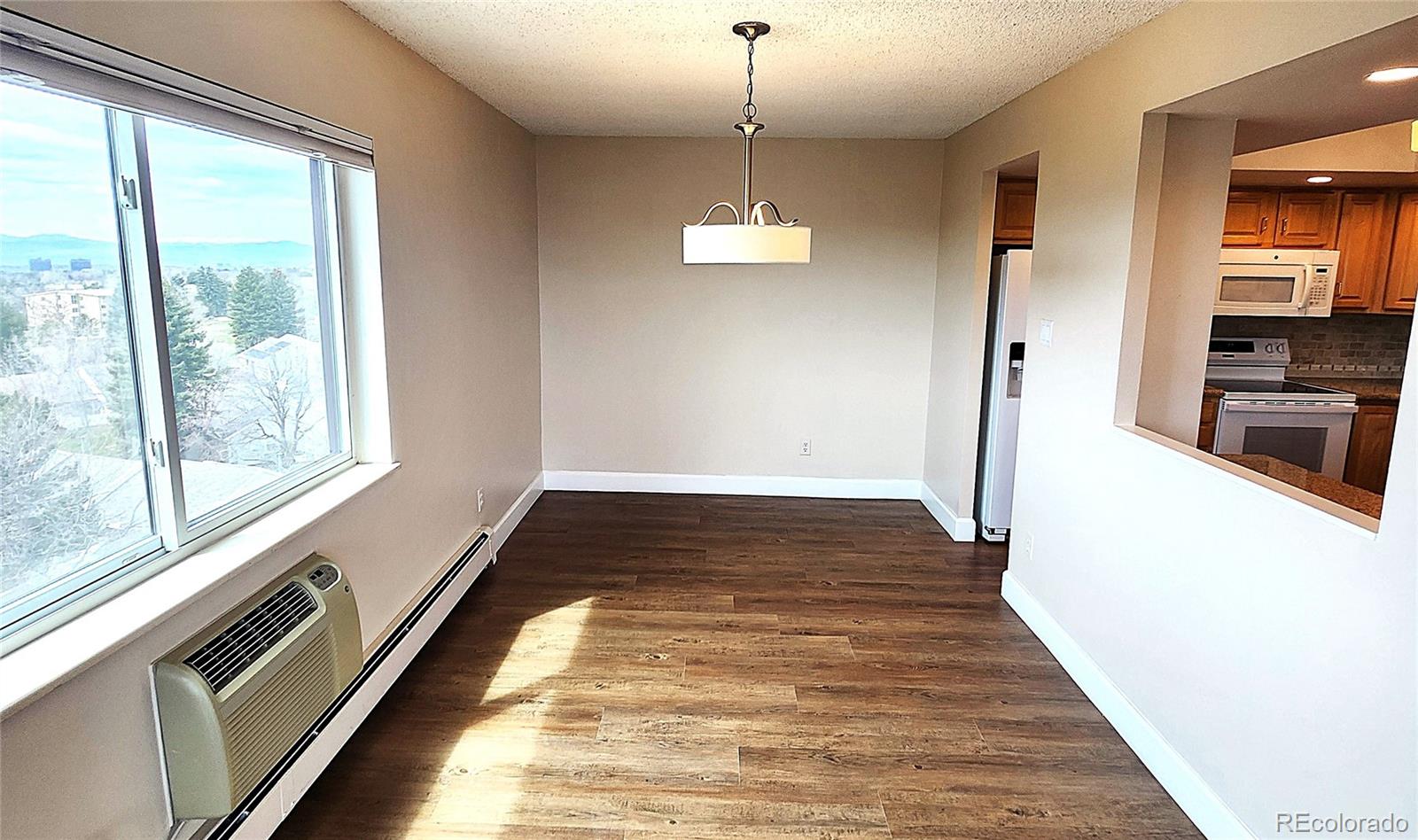 13890 East Marina Drive, Unit 602 Aurora, CO 80014 - Photo 5 of 27 a view of a hallway with wooden floor and a chandelier