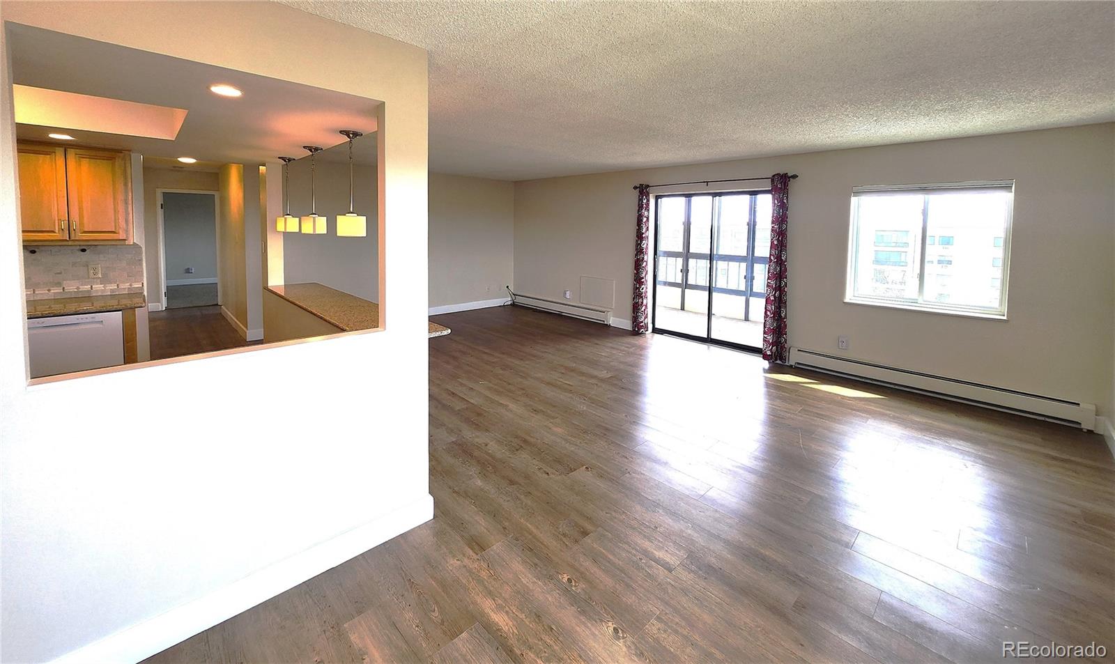 13890 East Marina Drive, Unit 602 Aurora, CO 80014 - Photo 6 of 27 an empty room with wooden floor and windows