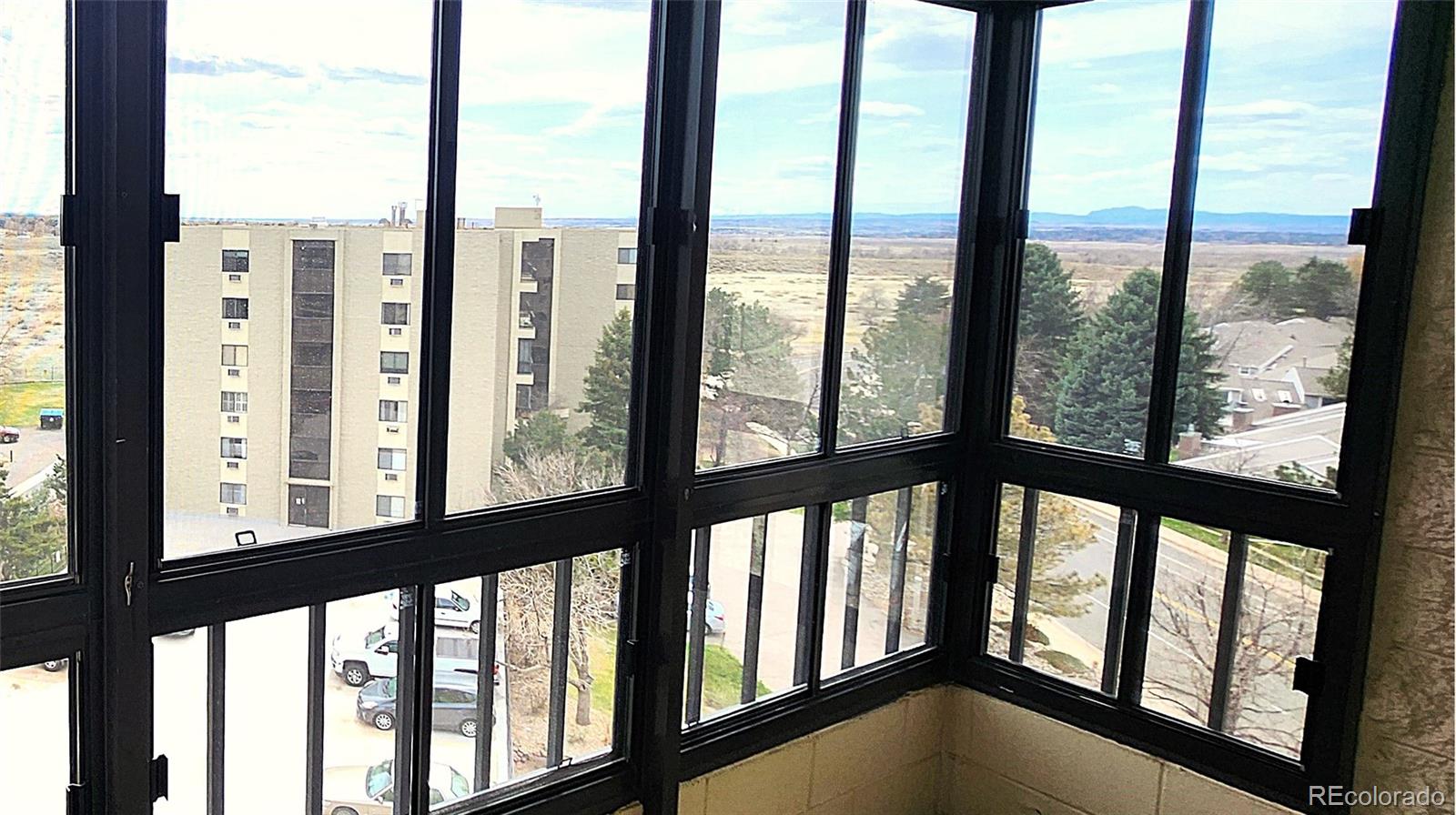 13890 East Marina Drive, Unit 602 Aurora, CO 80014 - Photo 9 of 27 a view of an empty room with city from a balcony