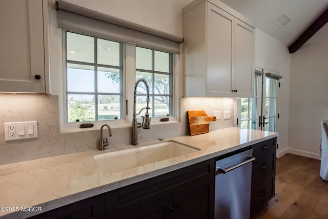 a living room with furniture a rug and a table