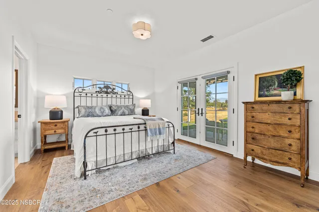 a bathroom with a granite countertop toilet sink and mirror