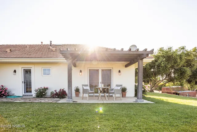 a view of a backyard with sitting area