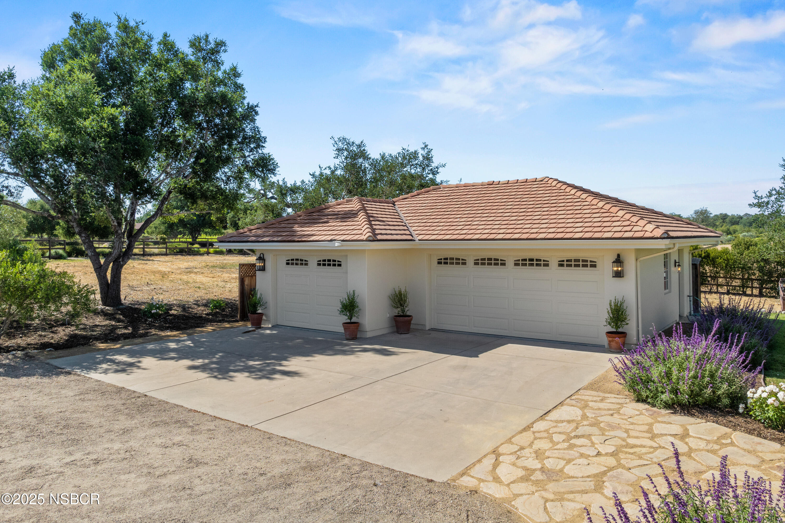 1740 Still Meadow Road Solvang, CA 93463 - Photo 4 of 43 a front view of a house with a yard and potted plants