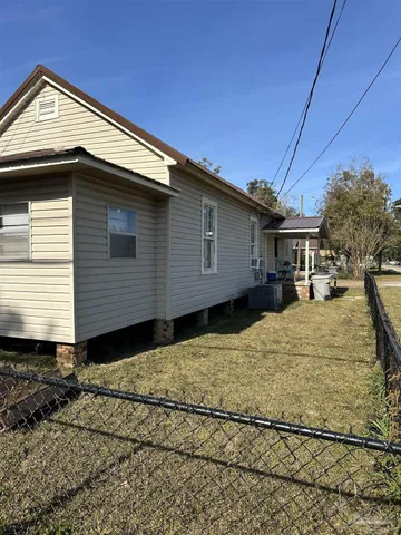 a view of house with backyard