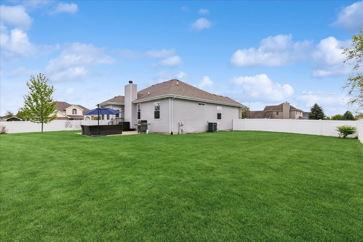1015 Meadow Path Manteno, IL 60950 - Photo 23 of 26 a view of white house with a big yard and large trees