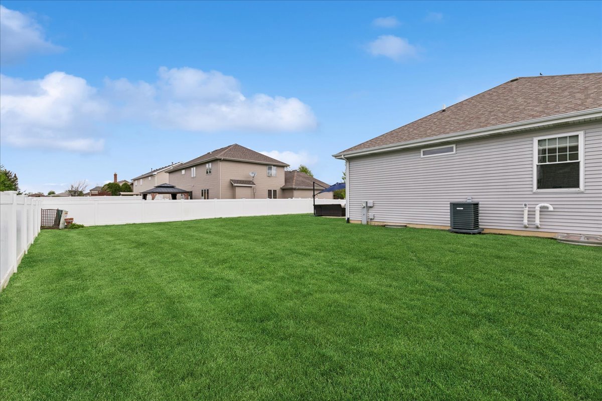 1015 Meadow Path Manteno, IL 60950 - Photo 24 of 26 a view of a backyard with plants and a garden