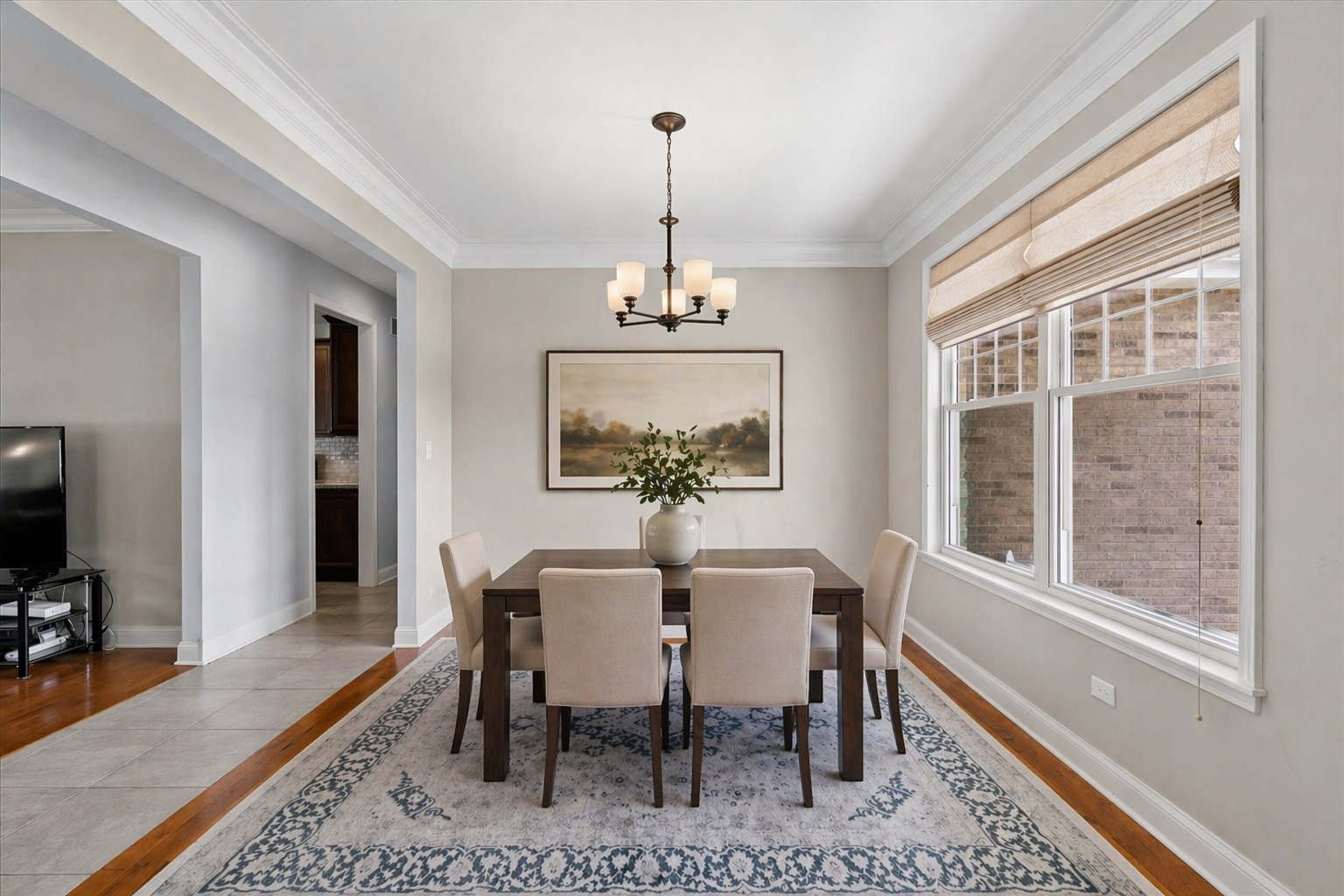 1015 Meadow Path Manteno, IL 60950 - Photo 10 of 26 a dining room with furniture a chandelier and wooden floor
