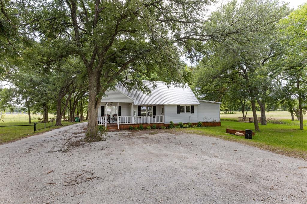 1001 S Highway Pilot Point, TX 76258 - Photo 12 of 16 a view of a house with a yard and large trees