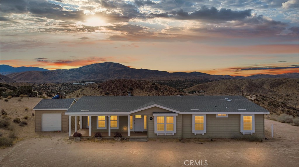 35380 Cheseboro Road Palmdale, CA 93552 - Photo 1 of 42 a front view of a house with a yard and mountain