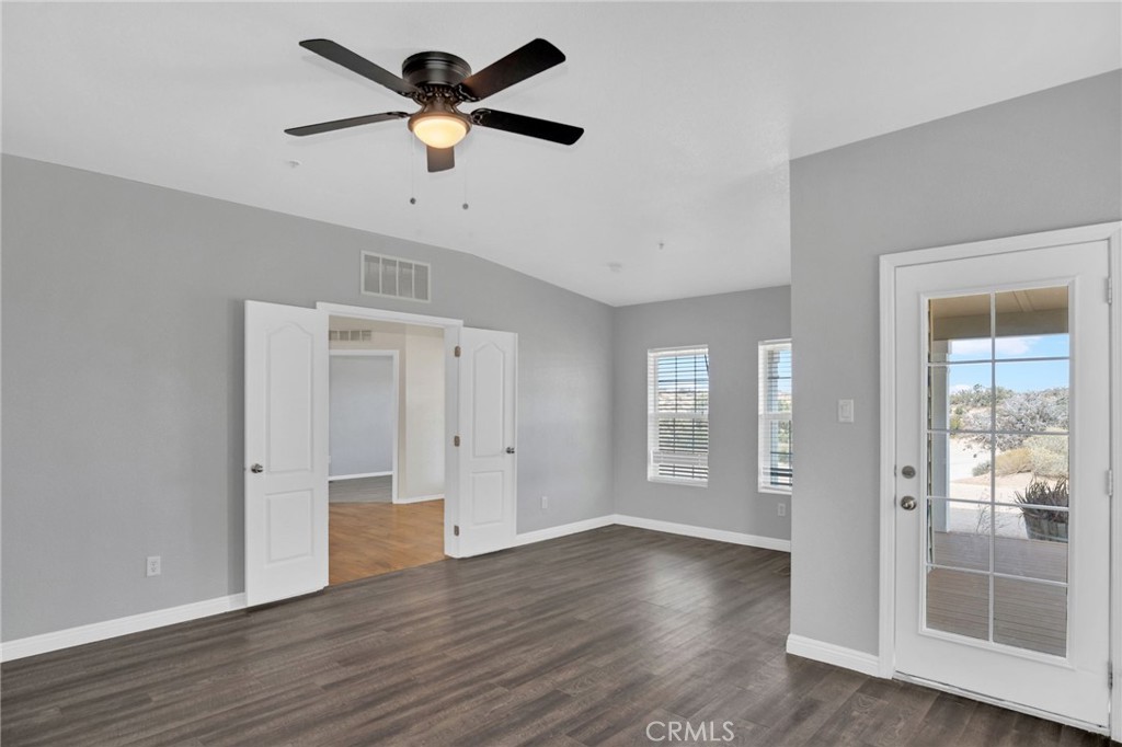 35380 Cheseboro Road Palmdale, CA 93552 - Photo 12 of 42 a view of an empty room with window and wooden floor
