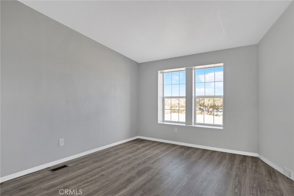 35380 Cheseboro Road Palmdale, CA 93552 - Photo 17 of 42 an empty room with wooden floor and windows