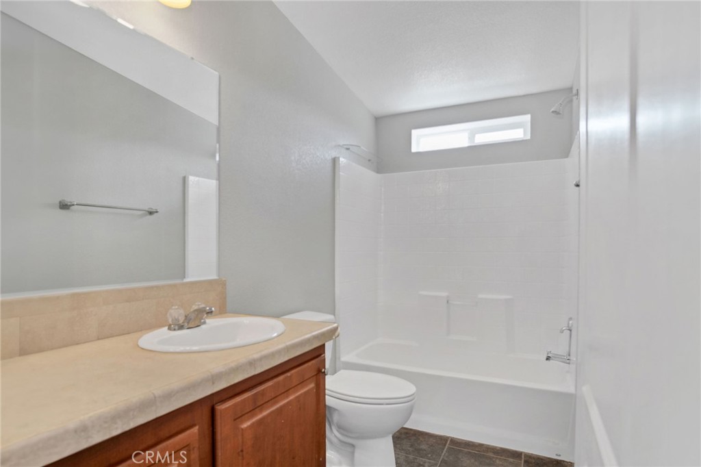 35380 Cheseboro Road Palmdale, CA 93552 - Photo 21 of 42 a bathroom with a granite countertop sink toilet and shower