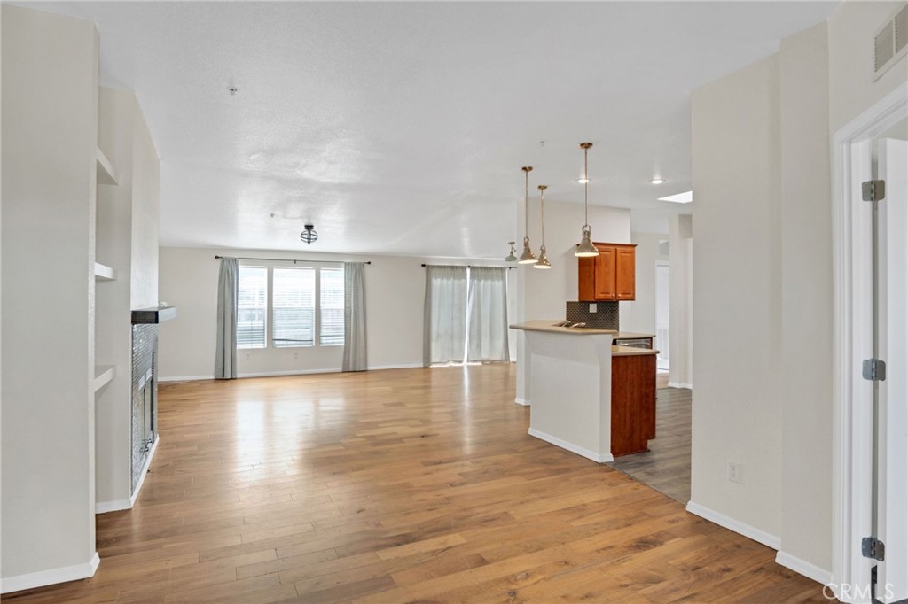 35380 Cheseboro Road Palmdale, CA 93552 - Photo 3 of 42 an empty room with wooden floor and windows