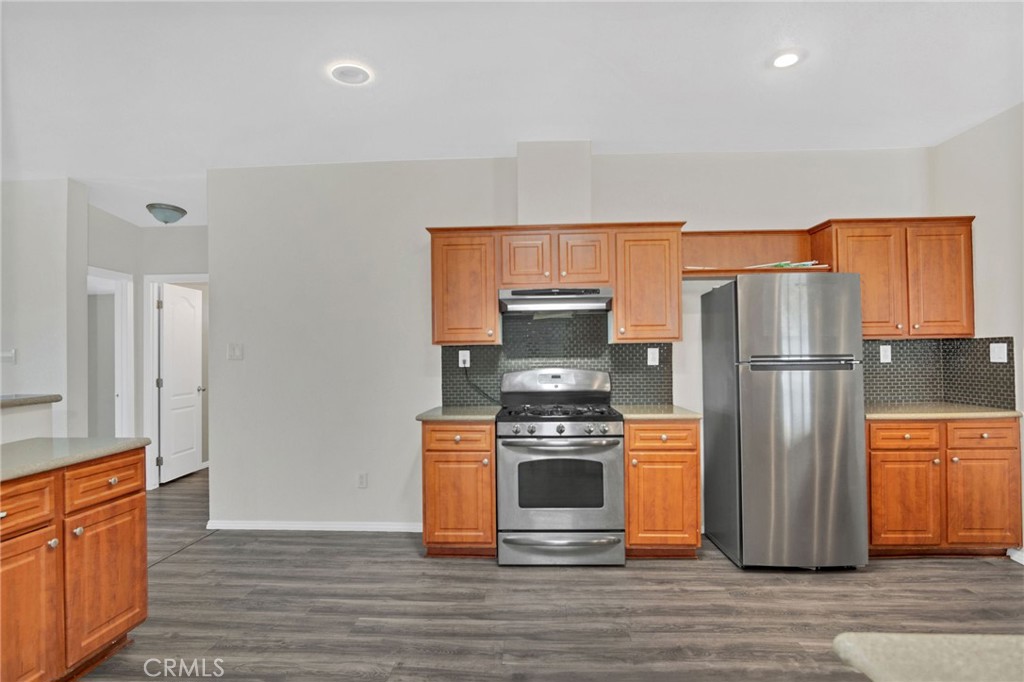 35380 Cheseboro Road Palmdale, CA 93552 - Photo 6 of 42 a kitchen with stainless steel appliances granite countertop a refrigerator stove and microwave