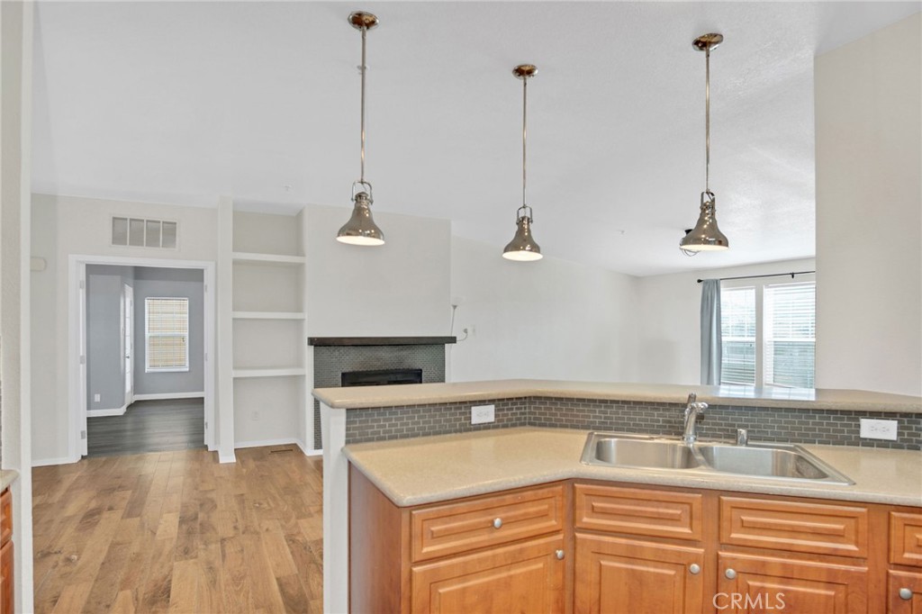 35380 Cheseboro Road Palmdale, CA 93552 - Photo 7 of 42 a kitchen with a sink a stove and a wooden floor