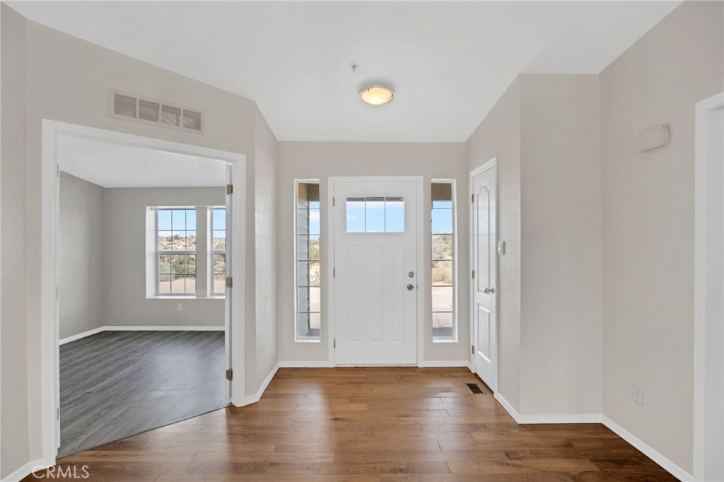 35380 Cheseboro Road Palmdale, CA 93552 - Photo 10 of 42 an empty room with wooden floor and windows