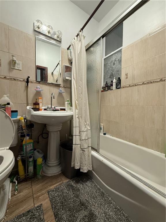 436 77th Street Brooklyn, NY 11209 - Photo 5 of 7 a bathroom with a sink a toilet and shower