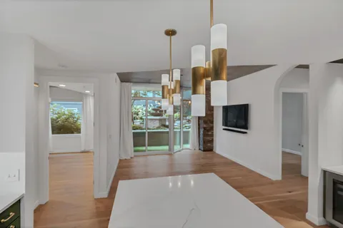 a kitchen with kitchen island a sink stainless steel appliances and cabinets