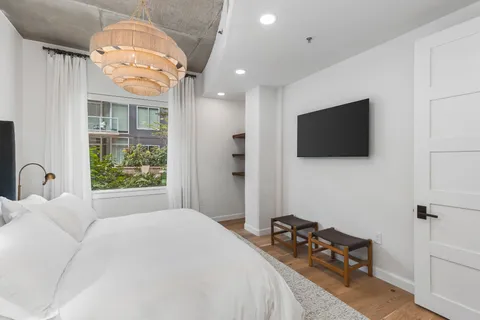 a bedroom with a bed and a chandelier