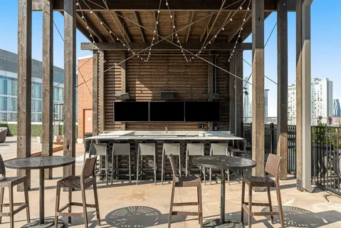 a kitchen with a table chairs and refrigerator